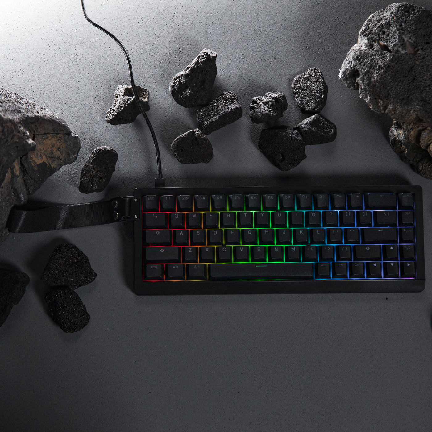 EPOMAKER HE68 Lite Black 65% gaming keyboard with A-RGB lighting in lifestyle shot with lava rocks